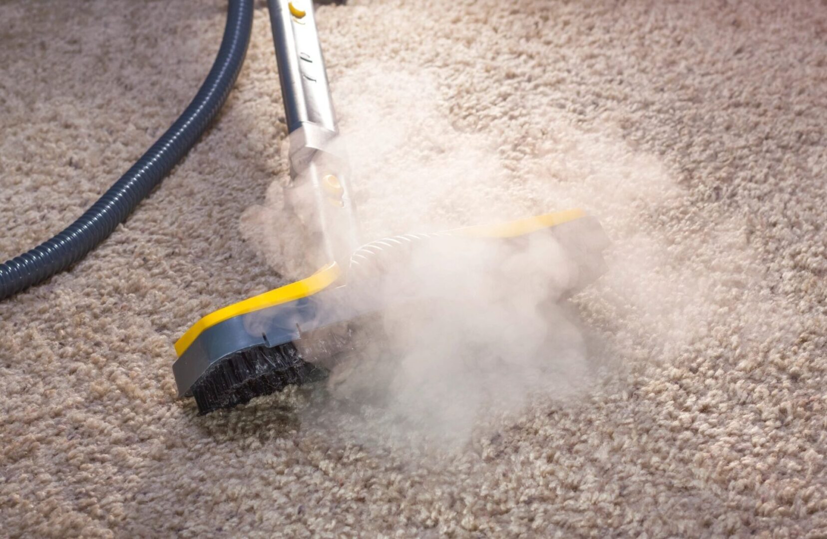 A steam cleaner is being used to clean the carpet.