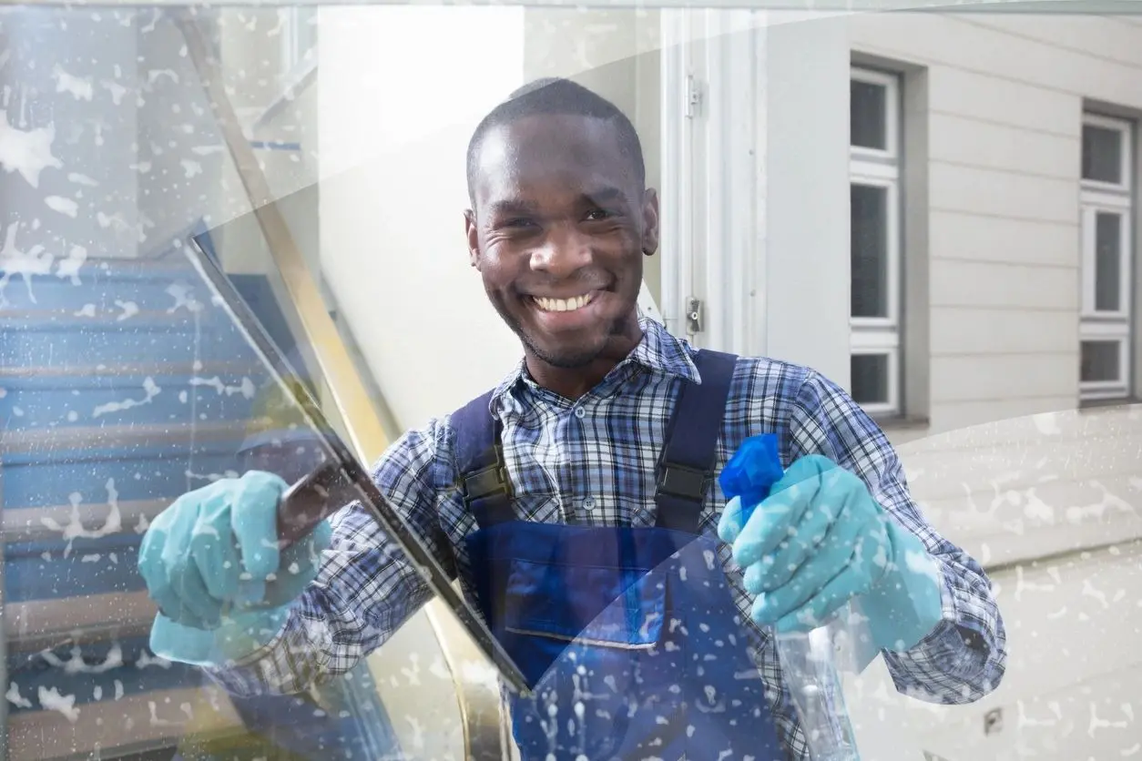 A man holding a glass window in his hands.