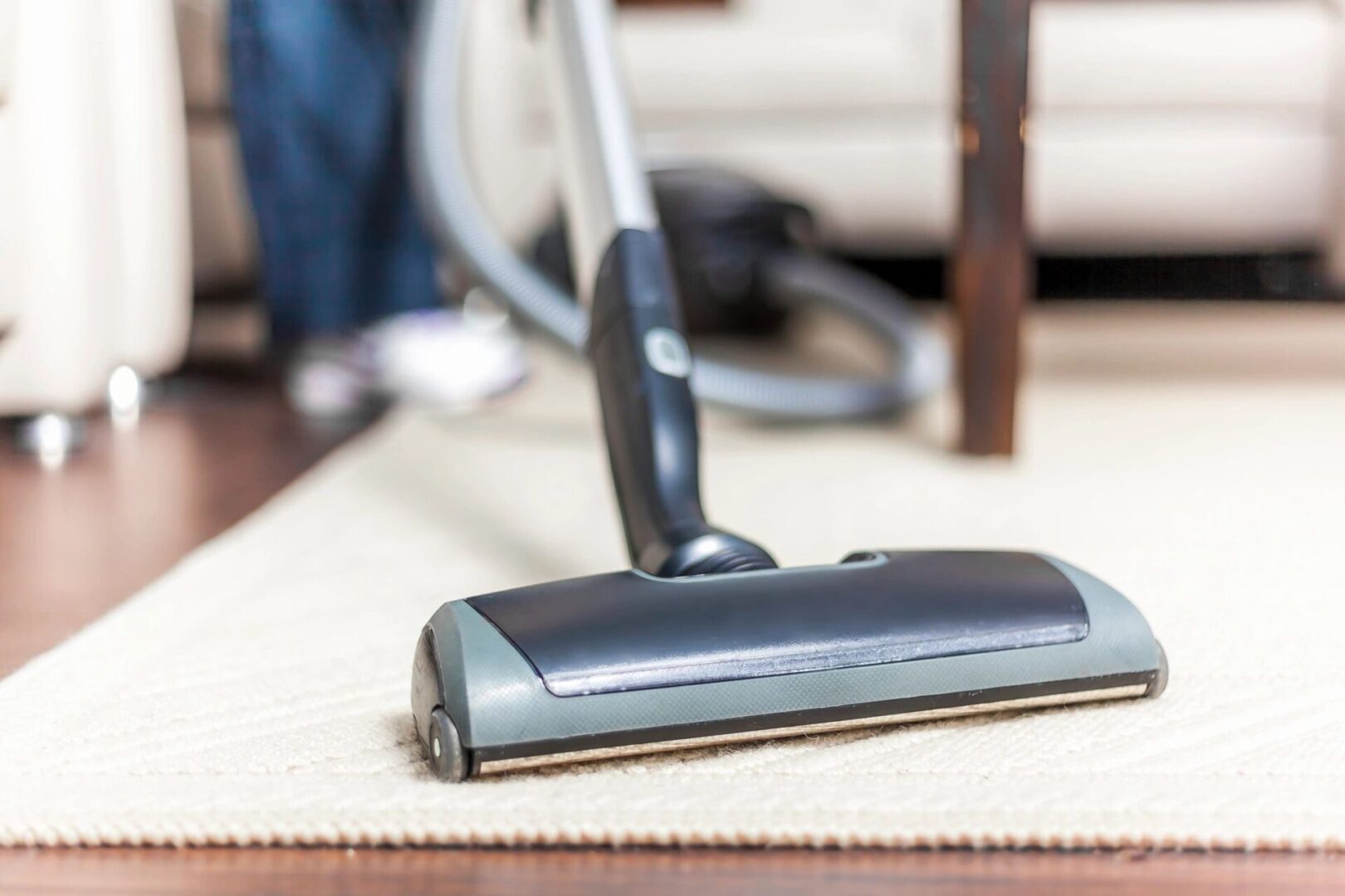 A vacuum cleaner is on the floor of a room.