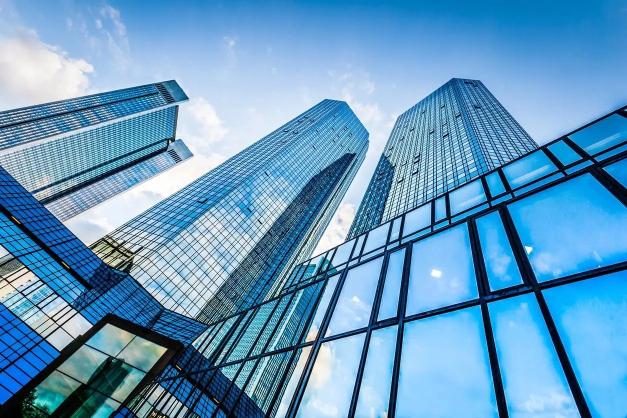 A group of tall buildings with glass windows.